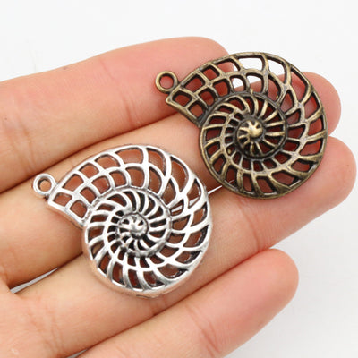 Openwork Spiral Shell Pendants arranged in the pictured color and finish options