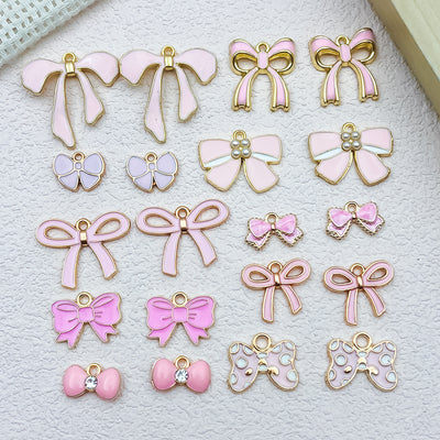Colorful bow and butterfly charms arranged on a light background