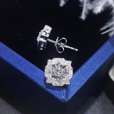 Silver flower scalloped halo CZ studs on blue velvet one face-up one side