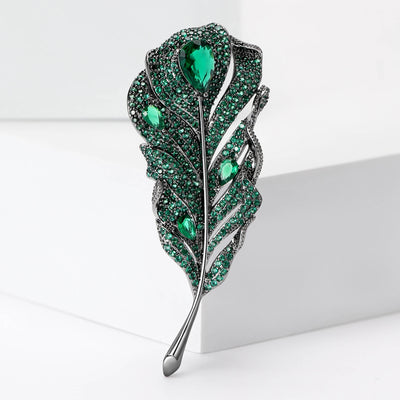 Product display showing a curved openwork feather densely set with small crystals