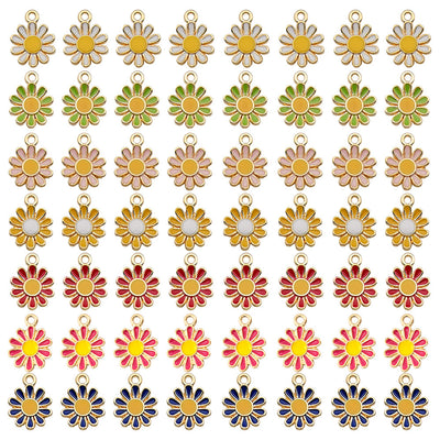 Colorful sun and daisy charms arranged on a light background