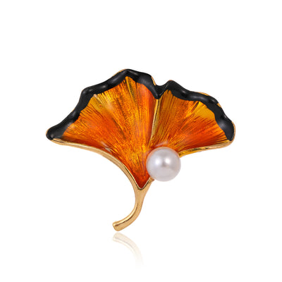 Front product view of the ginkgo leaf brooch pin in gold and black