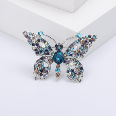 Front view of the dimensional butterfly brooch showing a dimensional butterfly set with clear and colored crystals