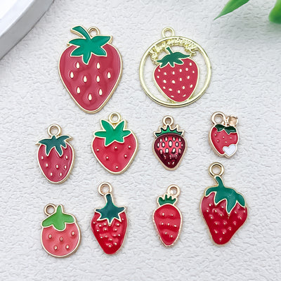 Colorful strawberry charms arranged on a light background