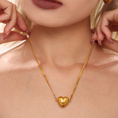 Gold split heart snake chain necklace worn at collarbone