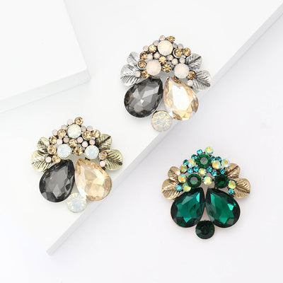 Front view of the floral teardrop crystal brooch showing a floral leaf cluster with faceted teardrop and round stones