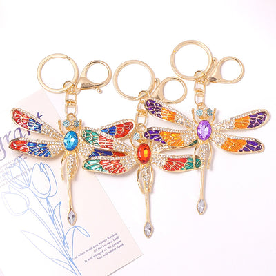 Three enamel rhinestone dragonfly keychains in blue red green purple orange