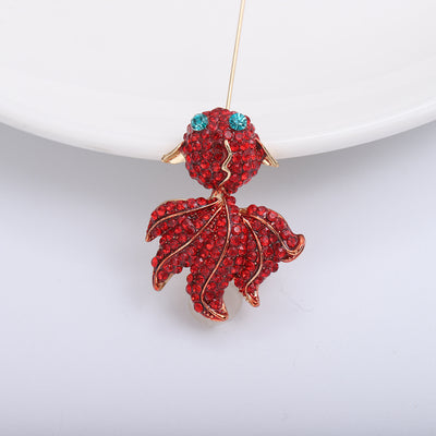 Front view of the red crystal goldfish brooch with gold tone details brooch and its color options