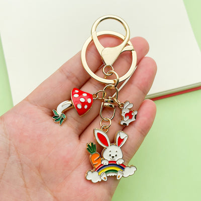 Image 1 showing a person holding a keychain with some charms.