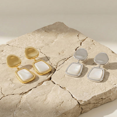 Display view of white shell geometric drop earrings in main image 1.