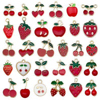 Colorful cherry and strawberry charms arranged on a light background