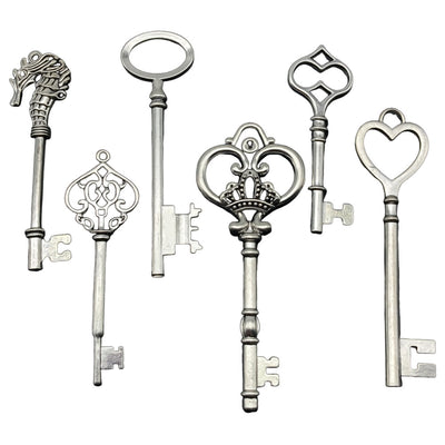 Antique silver heart charms arranged on a light background