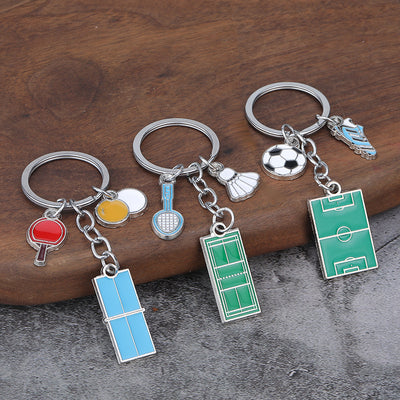 Four silver-tone sports keychains are displayed with soccer, basketball, badminton, and table tennis charms.