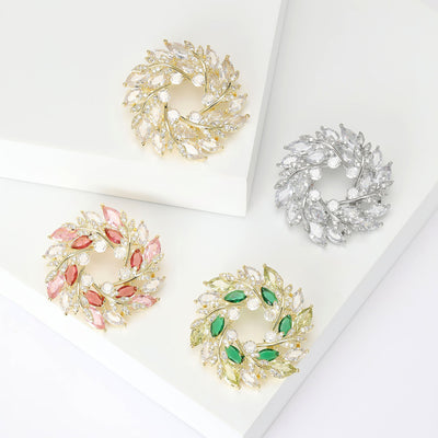 Product image 1 showing the curved crystal leaf wreath brooch in four color finishes.
