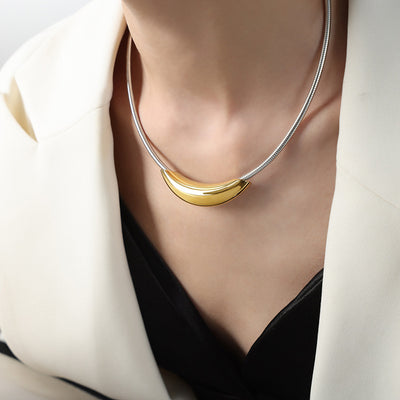 Model wearing gold crescent bar on silver snake chain necklace