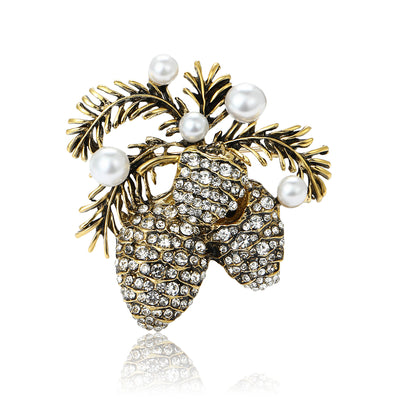 Front view showing the antique gold pinecone brooch with crystals and faux pearls