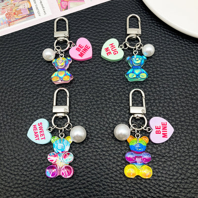 Overview showing the available color and design variations of the rainbow and green resin bear heart metal clasp keychai