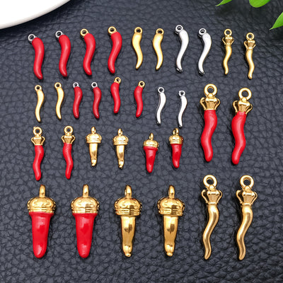 Blue chili pepper charms arranged on a light background
