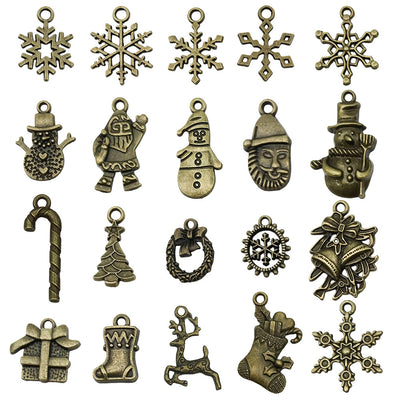 Gold-tone christmas tree and snowflake charms arranged on a light background