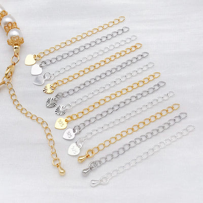 Front overview of five charm style metal extension chains arranged by finish and size