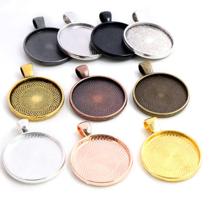 Front overview of round pendant tray settings in multiple sizes and finishes arranged on a light background