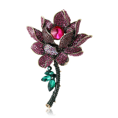 Magenta rhinestone lotus brooch with green stem on white