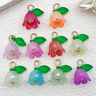Colorful leaf charms arranged on a light background