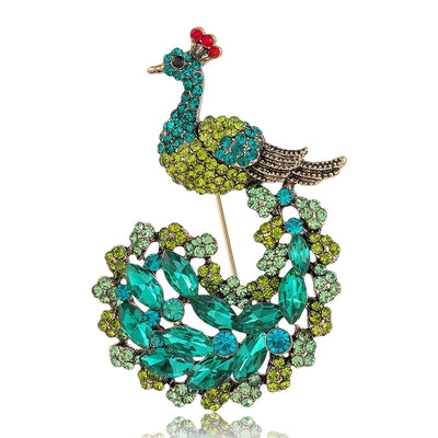 Front view showing the gold tone peacock brooch with green and blue crystal tail