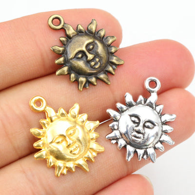 Grouped front view of smiling sun face metal charms in four finish options