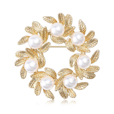 Gold pearl leaf wreath brooch on white