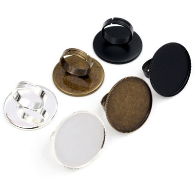 Overview of large round cabochon tray adjustable rings in three finishes arranged on white