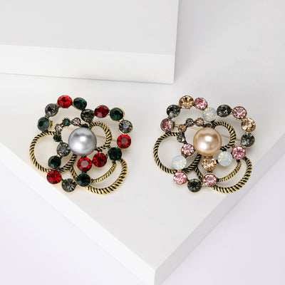 Layered Crystal and Pearl Flower Brooch shown against a white display background