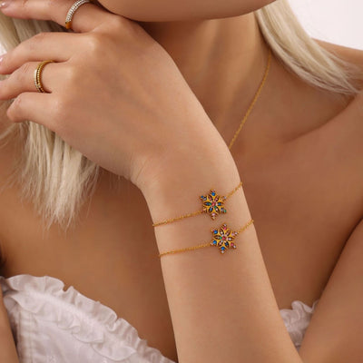 Gold multicolor zircon snowflake bracelets stacked on model wrist