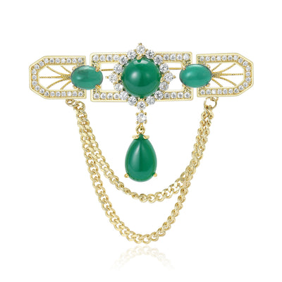 Green cabochon gold chain drape brooch front on white