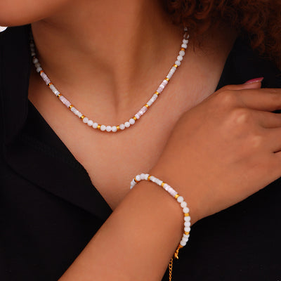 Model wearing white pink shell bead necklace and matching bracelet