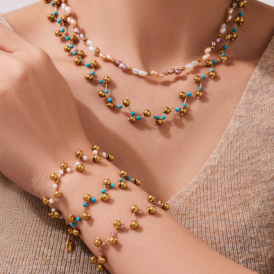 Layered gold bead stone necklaces and bracelets worn on model
