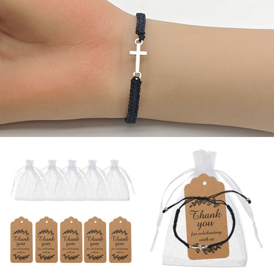 Black braided cord cross bracelet worn on wrist with packaging