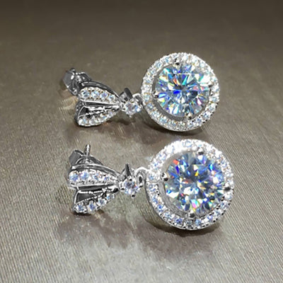 White gold heart-post round halo drop earrings on gray fabric