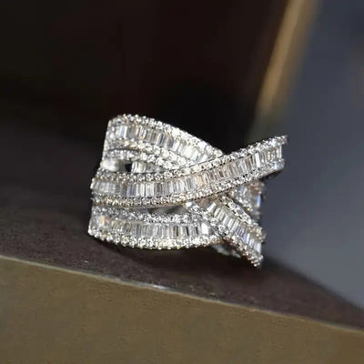 White gold multi-layer baguette crossover ring on dark block