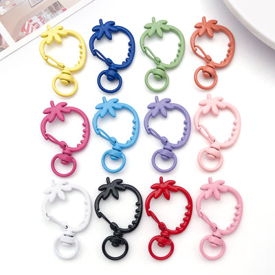 Colorful lobster clasp jewelry findings arranged on a light background