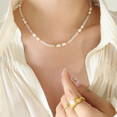 Gold freshwater pearl white stone bead necklace worn on open white blouse