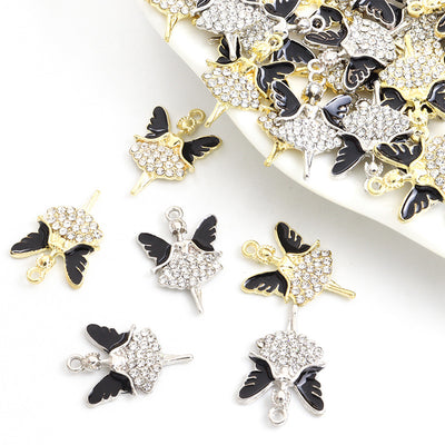 Assorted ballerina charms arranged on a white surface