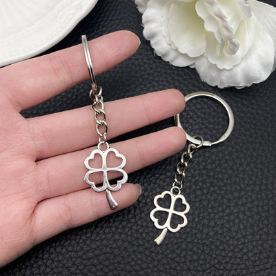 Overview showing the available color and design variations of the antique silver openwork four leaf clover metal keychai