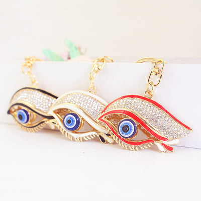 Three eye-shaped charms in black, white, and red with blue centerpieces and clear stones.