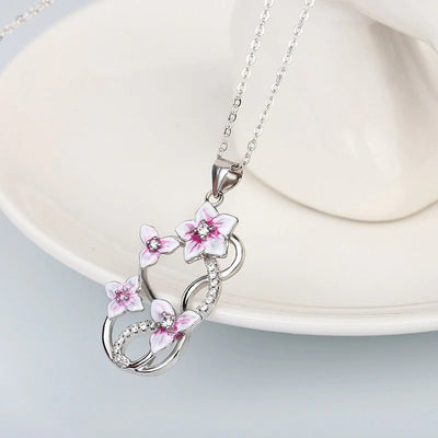 Front view of pink blossom and butterfly pendant necklace