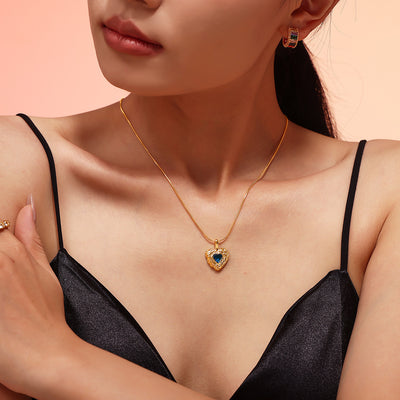 Gold hammered heart blue crystal pendant necklace worn on model