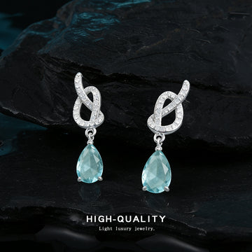 Silver Tone Clear Stone Knot And Aqua Teardrop Stud Earrings
