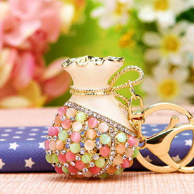 A styled group view shows the fortune pouch and charm keychain and attached key hardware.