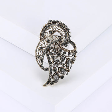 Gray Crystal Feather Brooch with Polished Metal and Decorative Accents