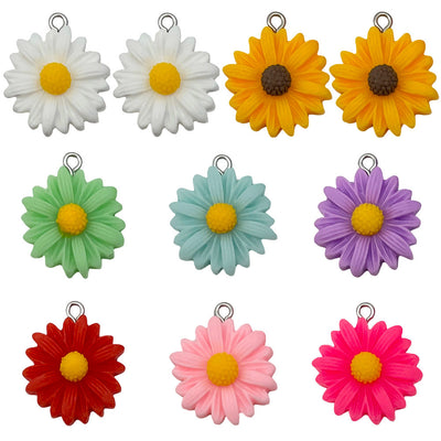 Multicolor daisy charms arranged on a light background
